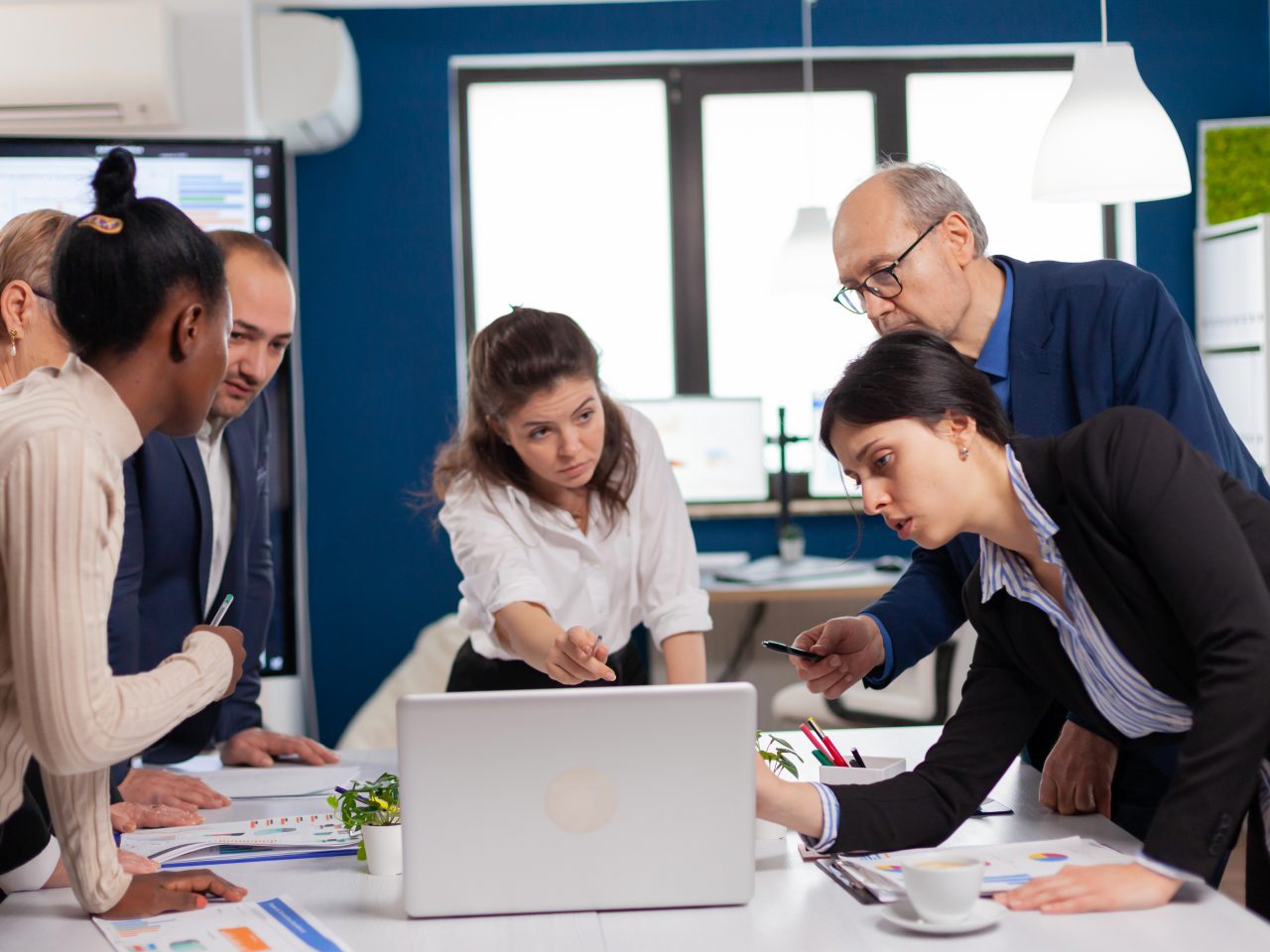 Multiethnic businesspeople meeting brainstorming, team leader sharing creative ideas planning. Multiethnic colleagues working planning success financial strategy discussing in office
